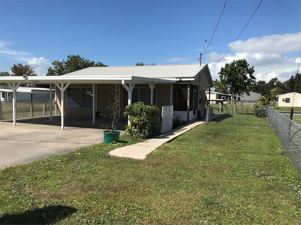 1112 Southeast 21st Street Okeechobee, FL 34974 - Photo 2 of 20 a view of a house with backyard and porch