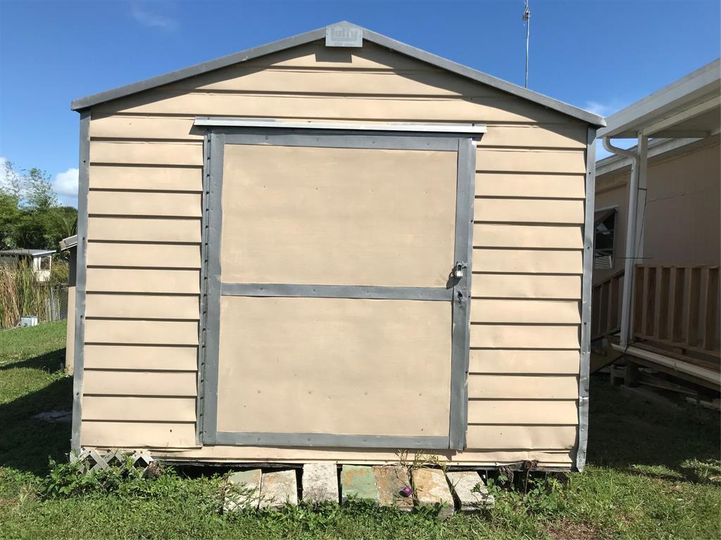 1112 Southeast 21st Street Okeechobee, FL 34974 - Photo 7 of 20 a front view of a house with a yard