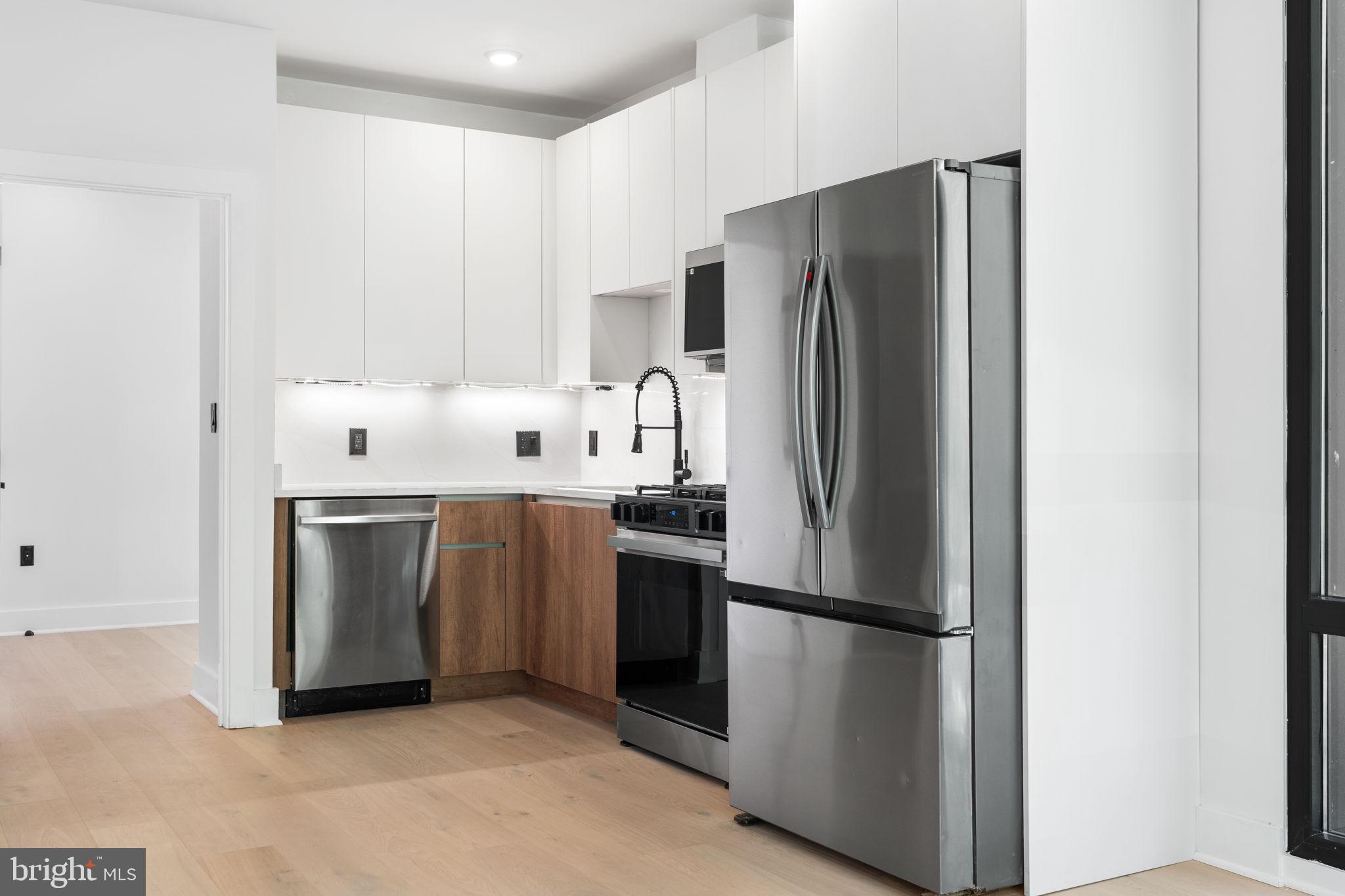 2504 41st Street Northwest, Unit 6 Washington, DC 20007 - Photo 5 of 13 a kitchen with stainless steel appliances a refrigerator and a sink