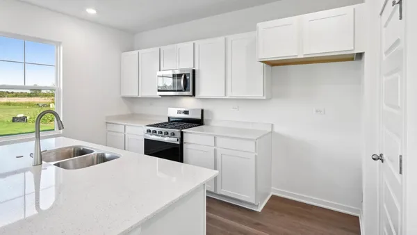 a kitchen with stainless steel appliances granite countertop a sink and a stove top oven