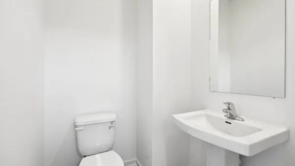 a bathroom with a toilet a sink and a mirror