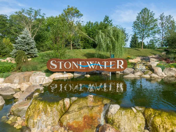 a sign that is sitting on a lake in the background