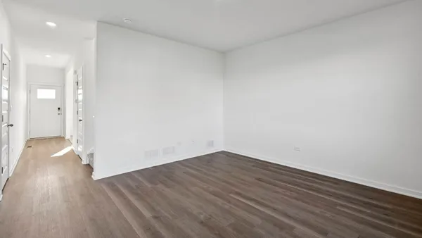 a view of a room with wooden floor and a sink