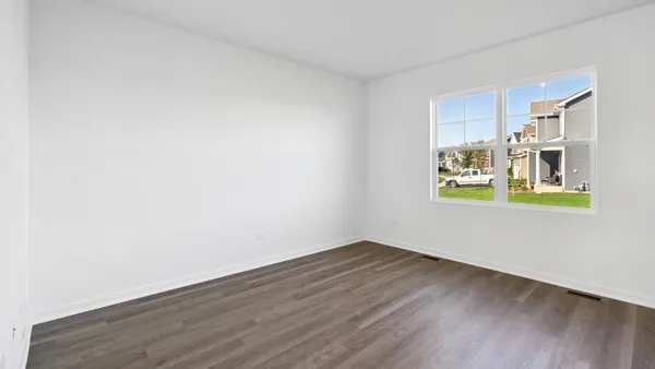 a view of a room with wooden floor and window