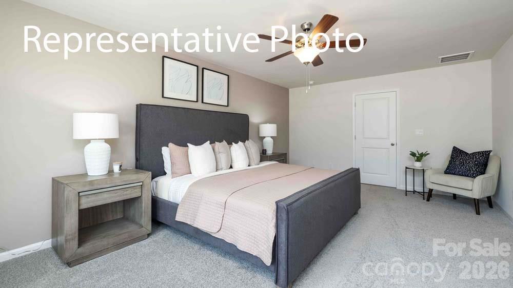 7592 Bainbridge Road Sherrills Ford, NC 28673 - Photo 14 of 28 a spacious bedroom with a bed and a lamp