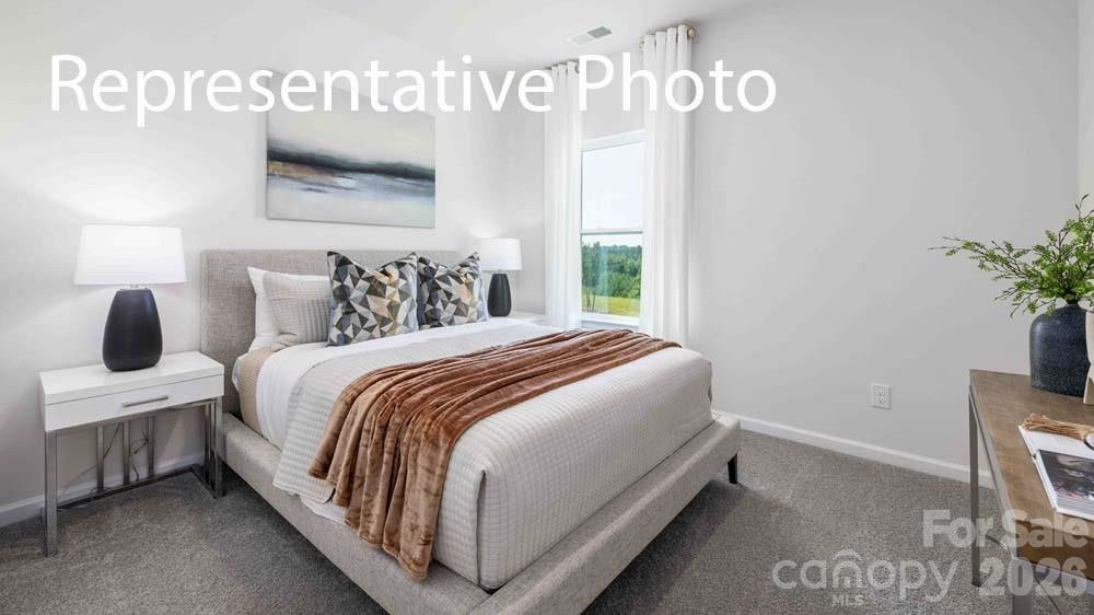 7592 Bainbridge Road Sherrills Ford, NC 28673 - Photo 17 of 28 a bedroom with a bed and window
