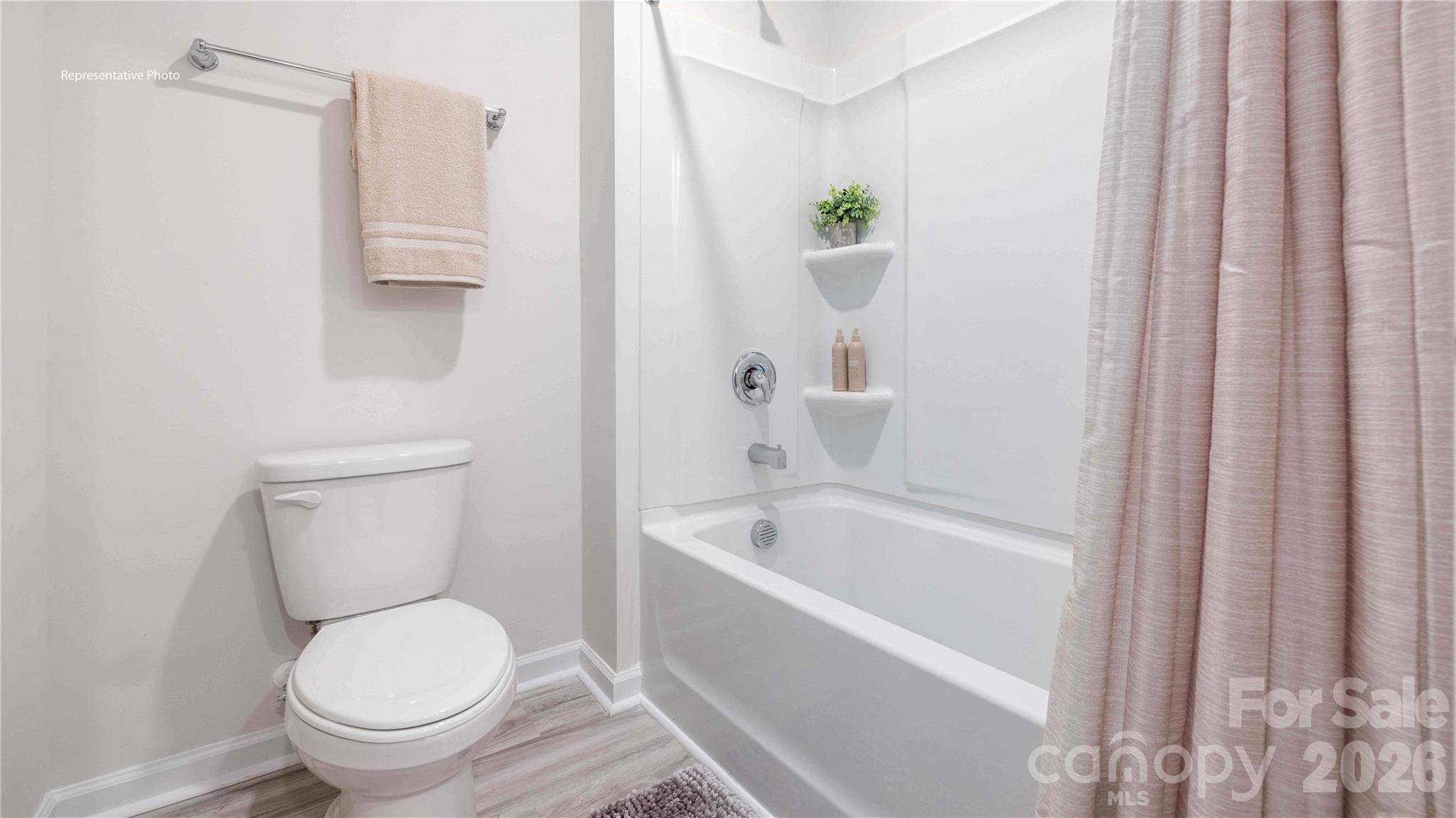 7592 Bainbridge Road Sherrills Ford, NC 28673 - Photo 21 of 28 a white toilet sitting next to a bath tub