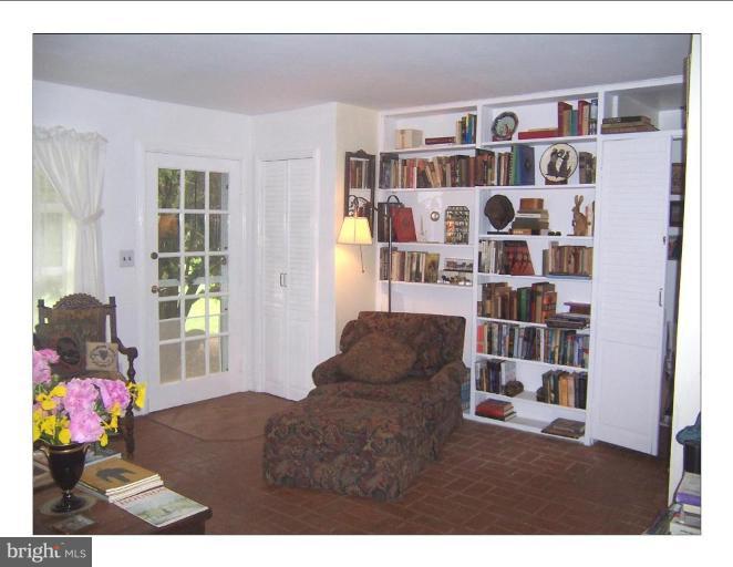 VIEW OF SOME OF THE BUILT IN BOOKCASES IN LR