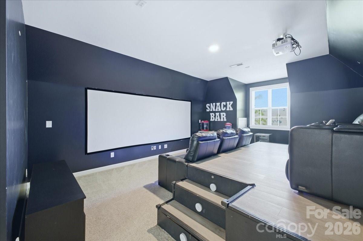 1825 Laveta Road Charlotte, NC 28269 - Photo 32 of 48 a living room with couches bookshelf and a flat screen tv