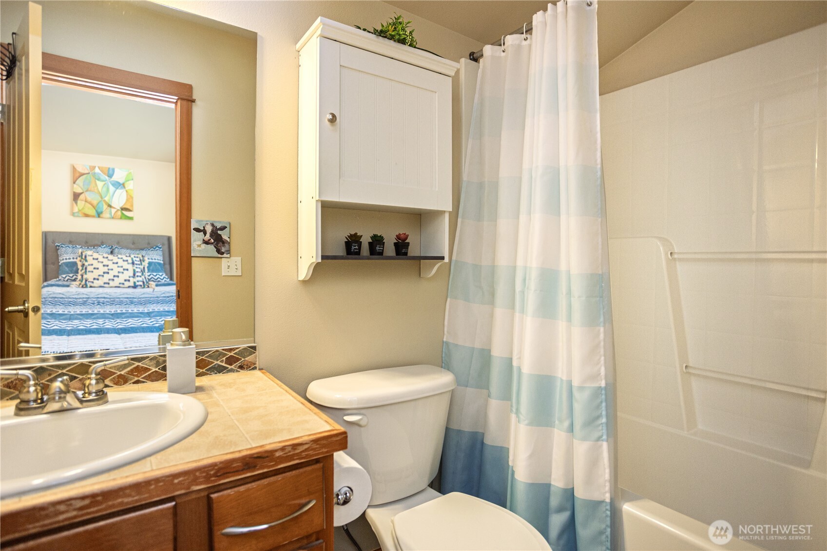 3314 Wetmore Avenue South, Unit B Seattle, WA 98144 - Photo 20 of 28 a bathroom with a sink a toilet a mirror and shower