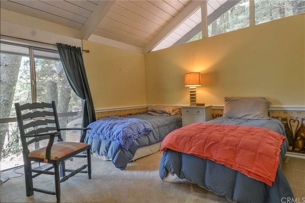 26415 Fernrock Road Twin Peaks, CA 92391 - Photo 18 of 23 a bedroom with two beds and a potted plant next to a window