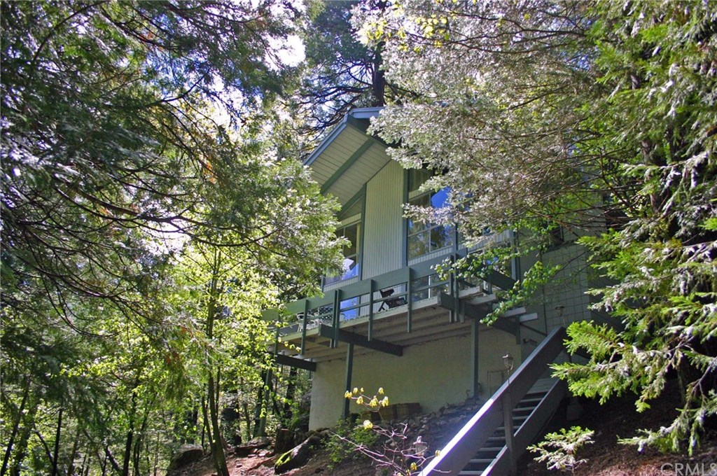 26415 Fernrock Road Twin Peaks, CA 92391 - Photo 2 of 23 a house is sitting in middle of forest