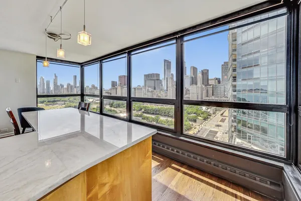 a view of a living room and a floor to ceiling window or kitchen