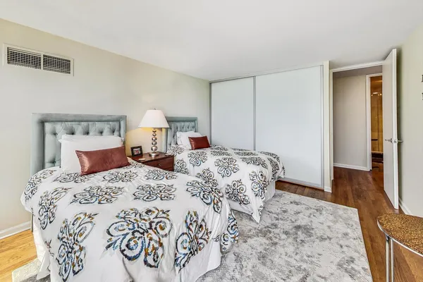 a bedroom with a large bed and a dresser