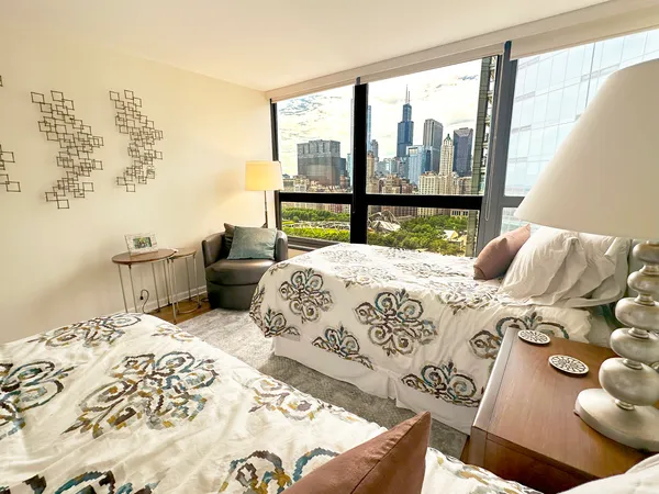 a bedroom with a bed and glass window