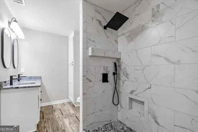a bathroom with a sink toilet and shower