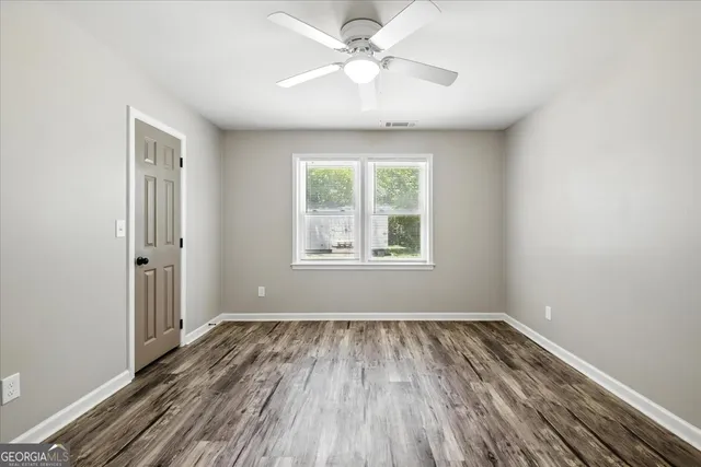 wooden floor in an empty room with a window