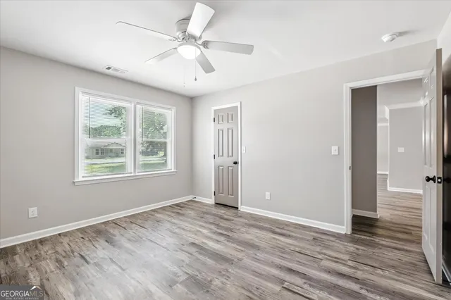 wooden floor in an empty room with a window
