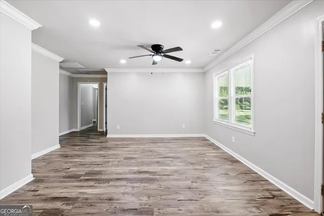 wooden floor in an empty room with a window