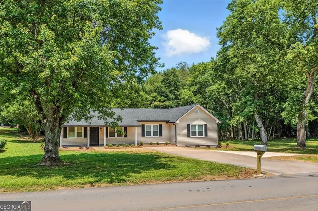 a front view of a house with a garden