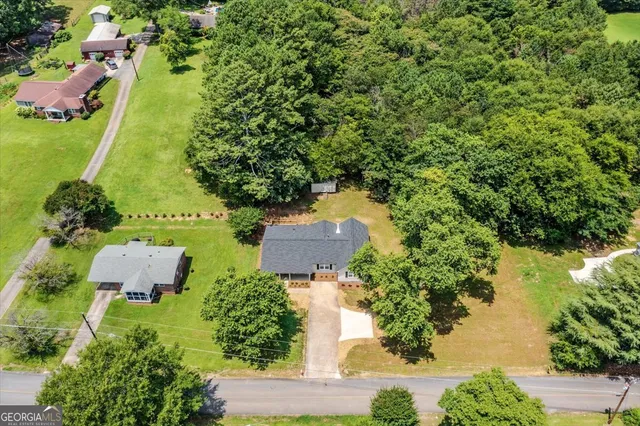 an aerial view of residential house with outdoor space and swimming pool