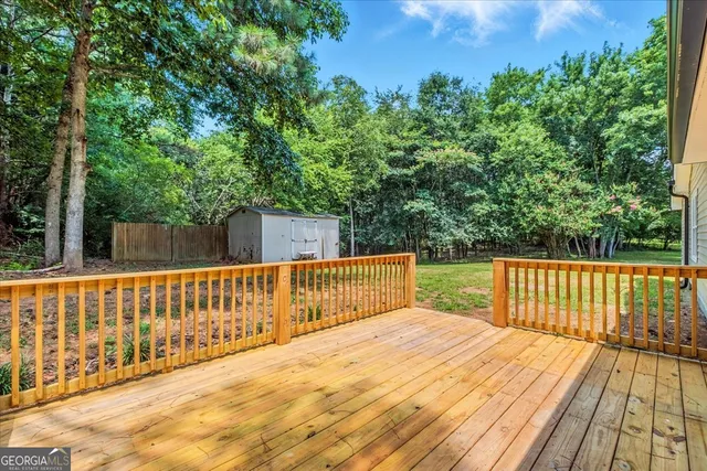 a view of balcony with wooden floor and fence