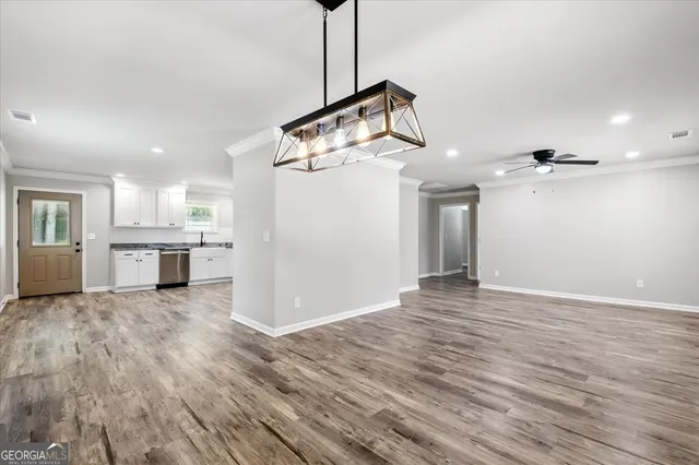 a view of a kitchen with a sink and wooden floor