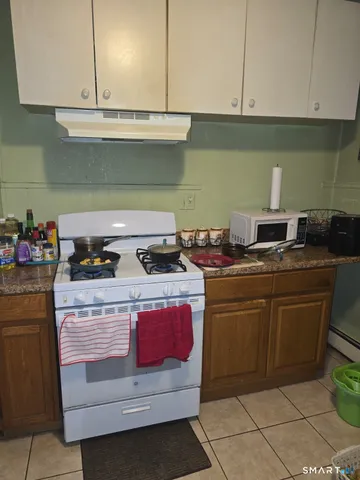 a kitchen with granite countertop cabinets stainless steel appliances and cabinets