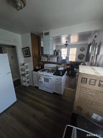 a kitchen with stainless steel appliances granite countertop a stove and a refrigerator