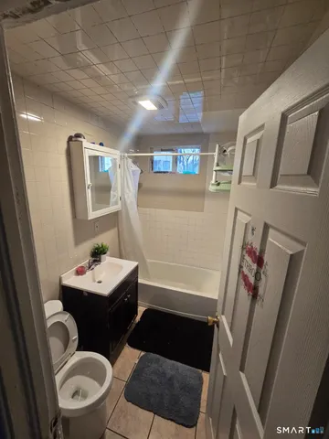 a bathroom with a sink toilet and a mirror