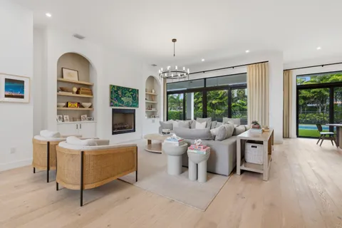 a living room with furniture a sink and a mirror