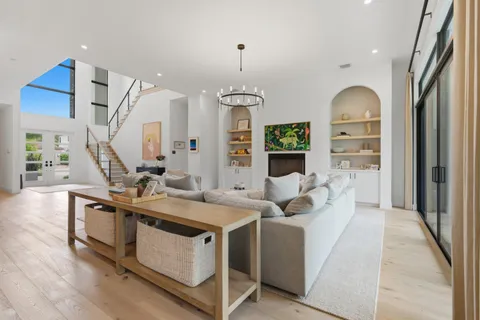 a kitchen with a table chairs sink and cabinets