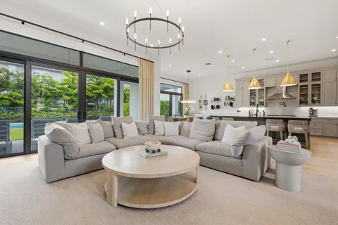 a living room with furniture and a chandelier