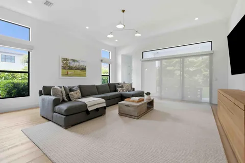 a living room with furniture and a chandelier