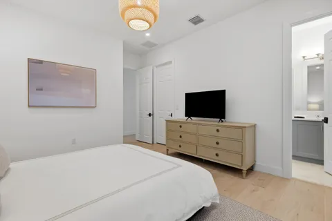 a bathroom with a bathtub shower sink and mirror