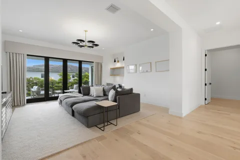 a bedroom with a bed and a chandelier