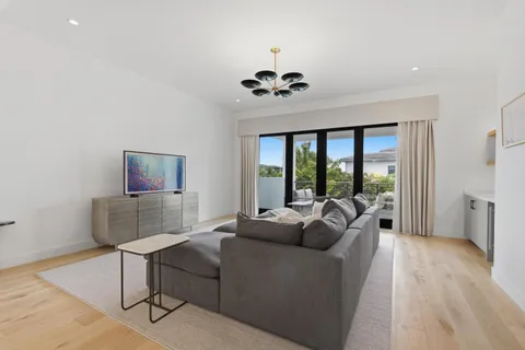 a living room with furniture a window and a flat screen tv