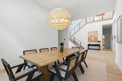 a view of a dining room with furniture and chandelier