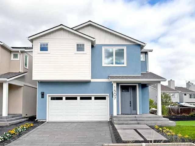 a front view of a house with a garden
