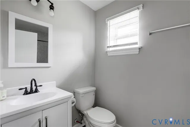 a white toilet sitting next to a bathroom sink