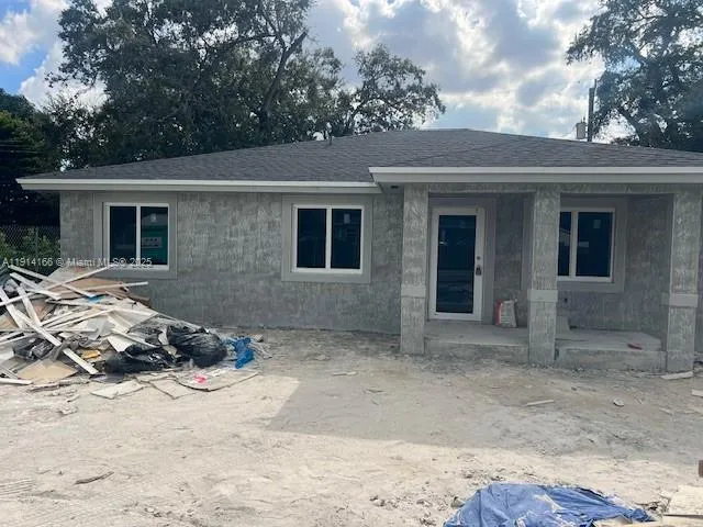 a view of a house with a yard covered in snow