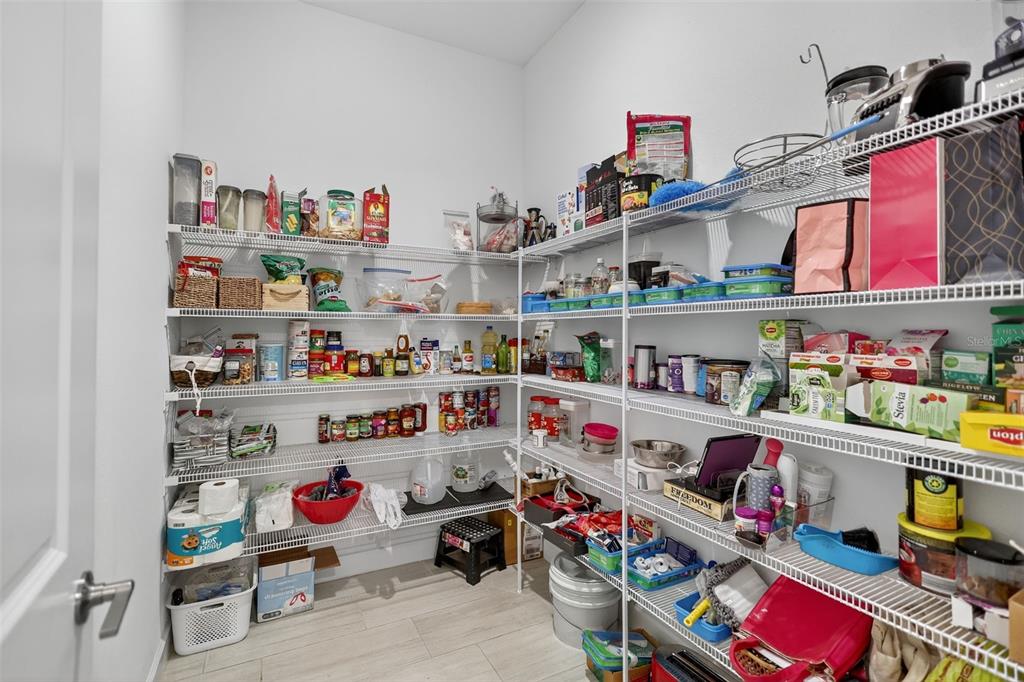 17109 Star Banks Street Wimauma, FL 33598 - Photo 13 of 60 a utility room with lots of clutter and cabinets