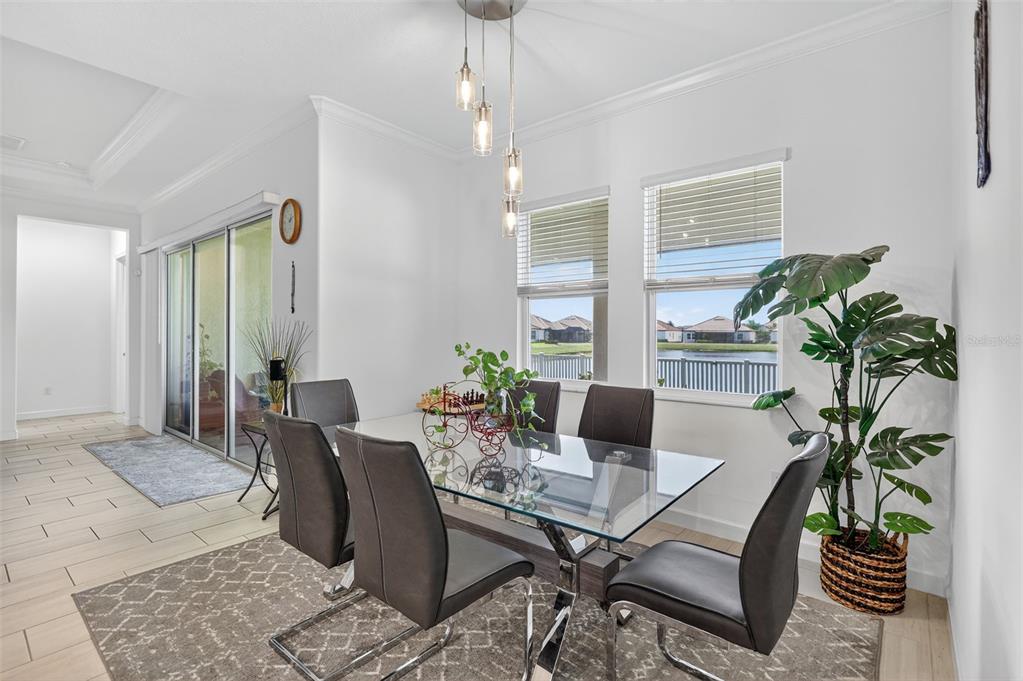17109 Star Banks Street Wimauma, FL 33598 - Photo 15 of 60 a view of a dining room with furniture window and wooden floor
