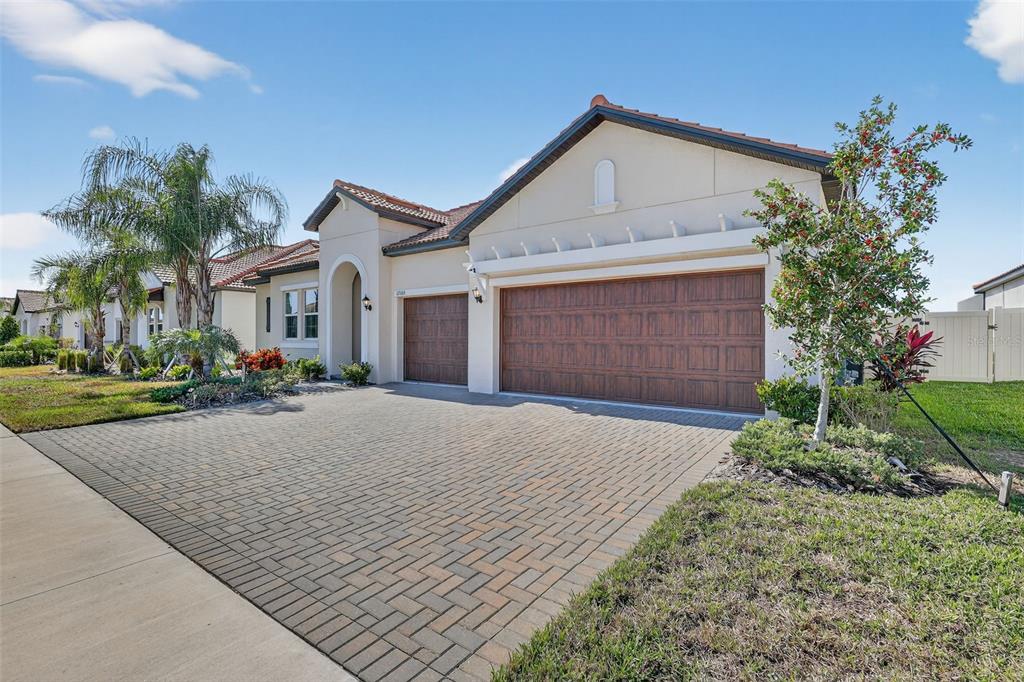 17109 Star Banks Street Wimauma, FL 33598 - Photo 2 of 60 a front view of a house with a yard and garage
