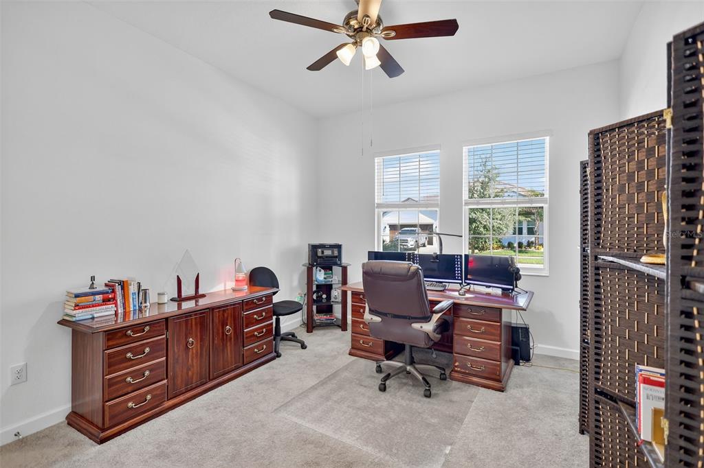 17109 Star Banks Street Wimauma, FL 33598 - Photo 22 of 60 a view of a workspace with furniture and a window