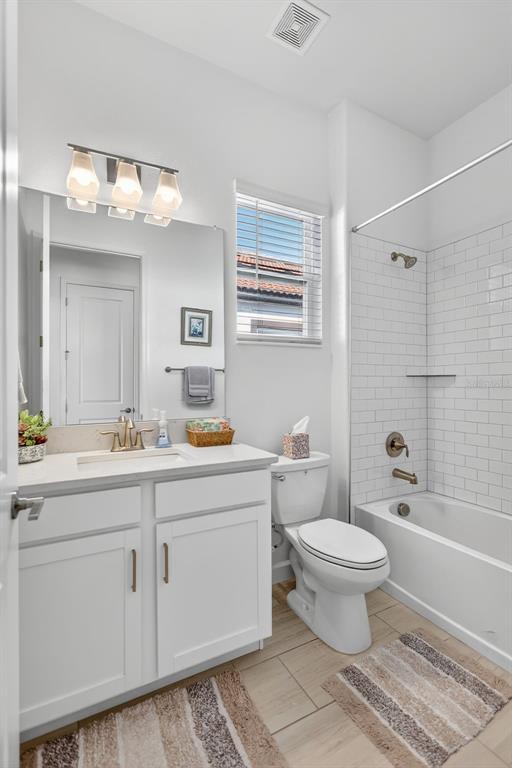 17109 Star Banks Street Wimauma, FL 33598 - Photo 27 of 60 a bathroom with a toilet sink and mirror