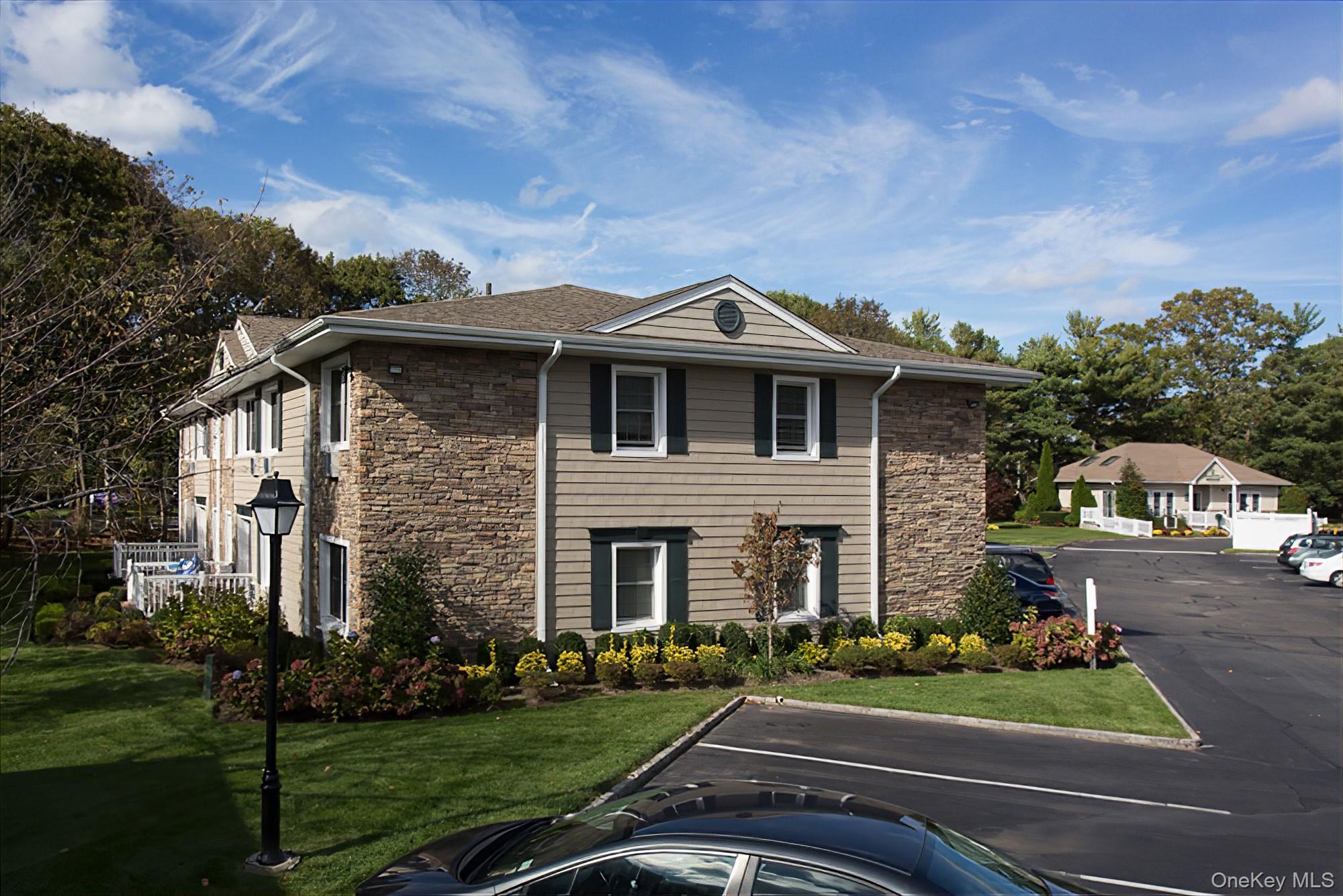 655 Belle Terre Road, Unit 44 Port Jefferson, NY 11777 - Photo 1 of 1 front view of house with a yard