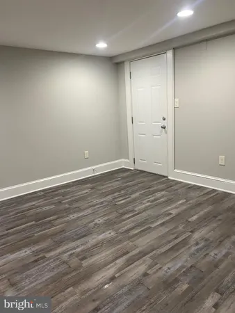 a view of room with wooden floor