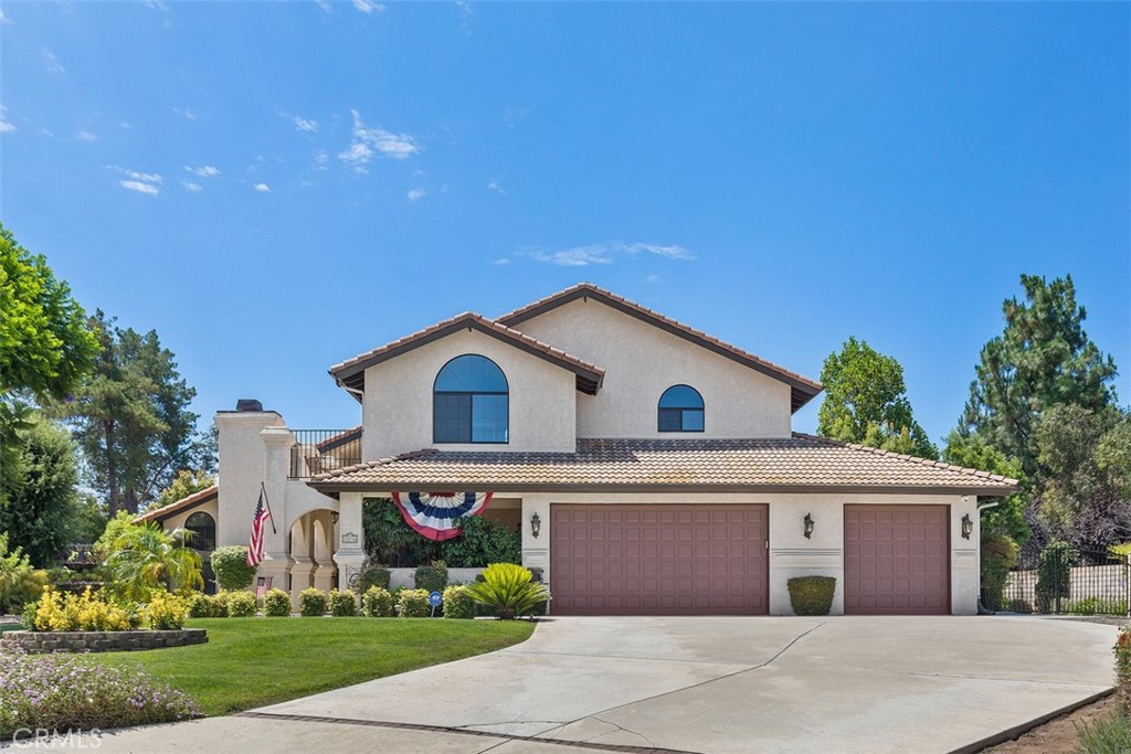 1276 Coco Court Riverside, CA 92506 - Photo 1 of 1 a front view of a house with a garden and plants
