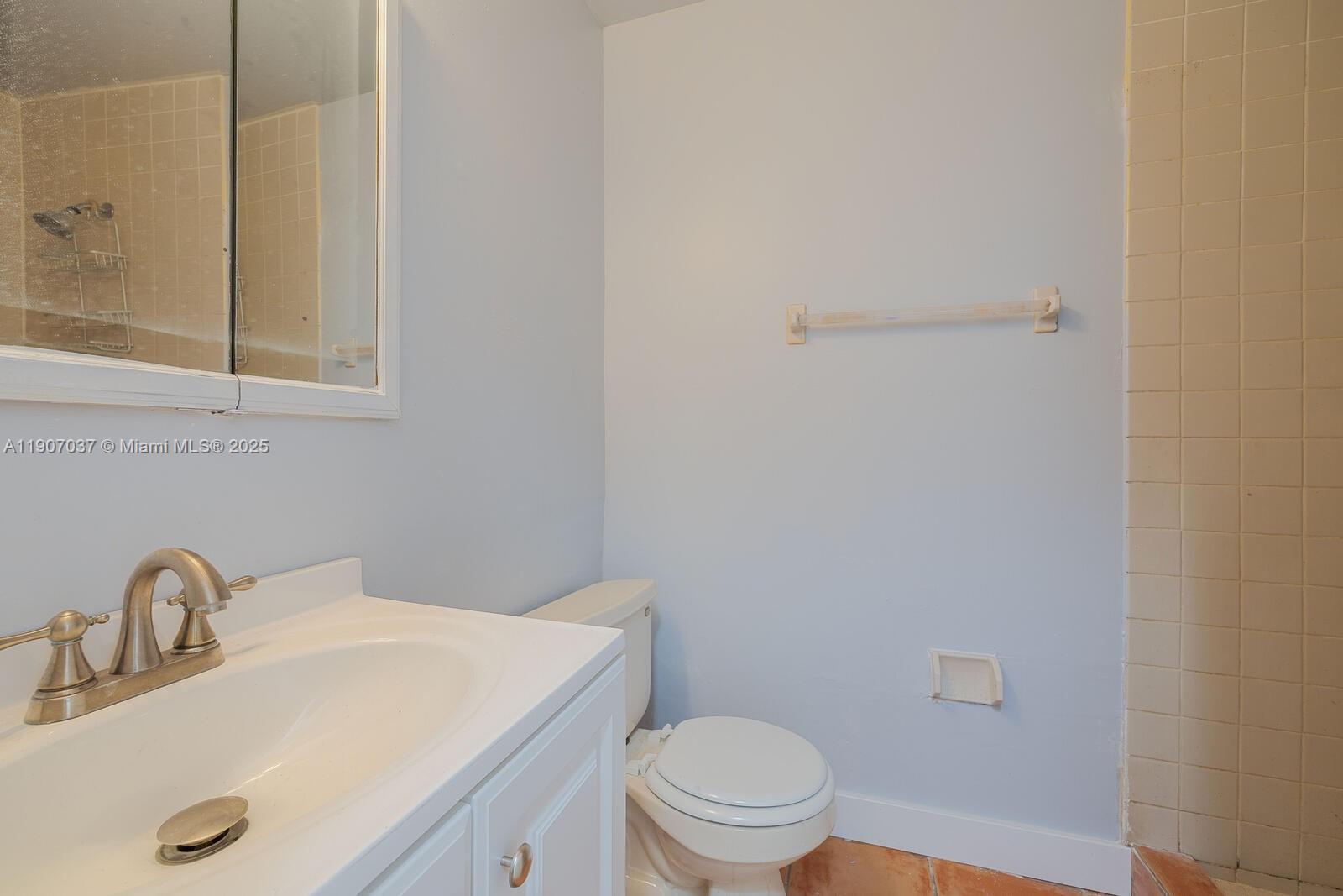 28147 Southwest 142nd Court Homestead, FL 33033 - Photo 13 of 16 a bathroom with a sink a toilet and vanity